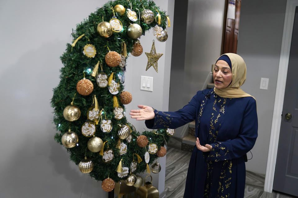 Suzanne Jaber of The Eid Shop looks her Green Crescent Eid Tree she created, in Dearborn Heights, Mich., on Monday, March 27, 2023. More businesses are selling Ramadan and Eid items, including DIY kits, lanterns and napkin holders. She began crafting and selling her own dedicated Ramadan and Eid decorations and now ships items across the U.S. and world. (AP Photo/Carlos Osorio)