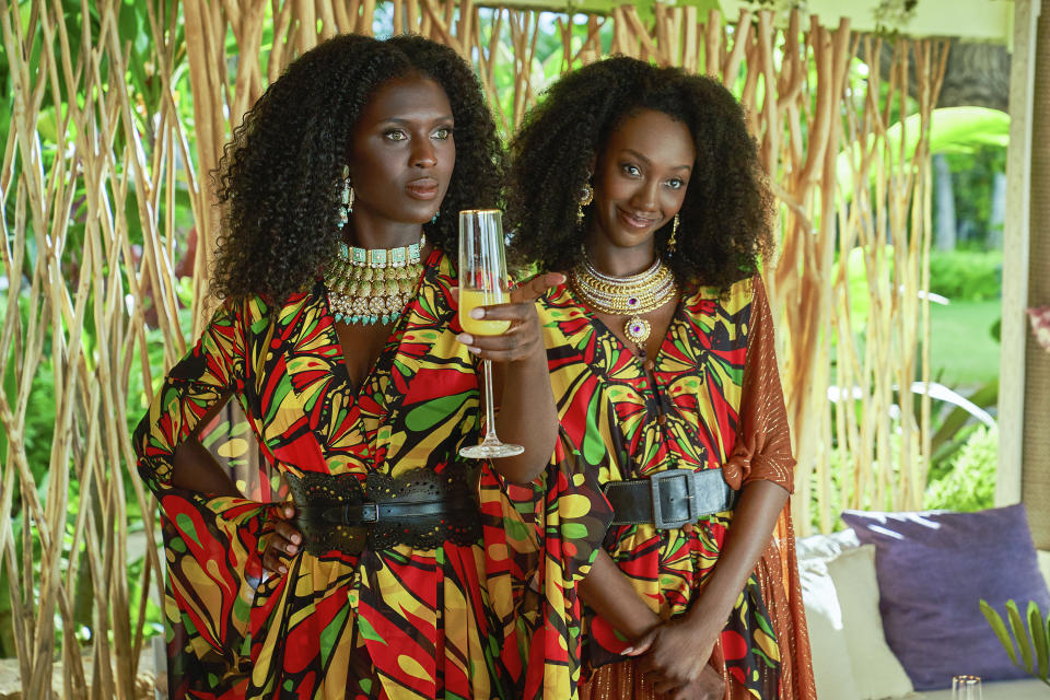 This image released by Netflix shows Jodie Turner-Smith, left, and Zurin Villanueva in a scene from the film "Murder Mystery 2." (Scott Yamano/Netflix via AP)