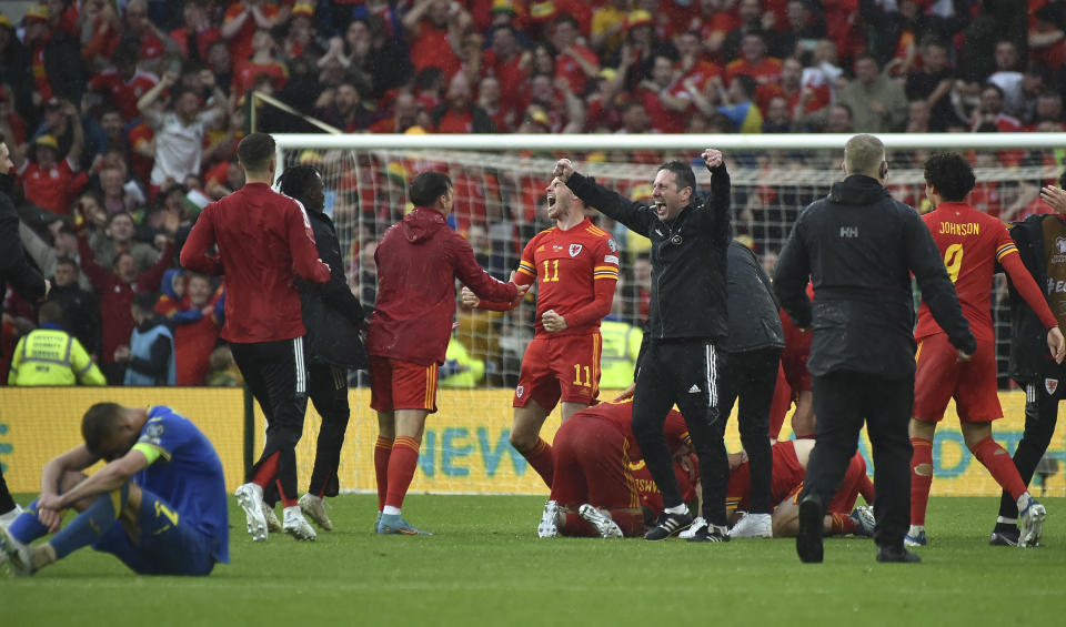 Wales players celebrate at the end of the World Cup 2022 qualifying play-off soccer match between Wales and Ukraine at Cardiff City Stadium, in Cardiff, Wales, Sunday, June 5, 2022. Wales won 1-0. (AP Photo/Rui Vieira)