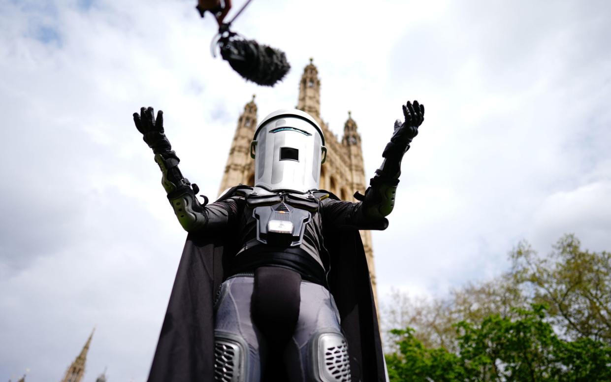 Count Binface, one of the Mayor of London election candidates, is pictured today posing outside the Houses of Parliament on College Green, Westminster