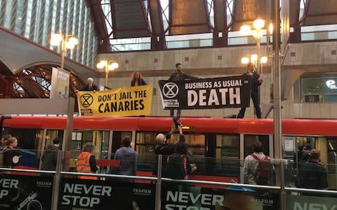 Activists climbed on top of a train at Canary Wharf station - Credit: Jack Hardy