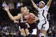 FILE - In this Sunday, March 1, 2020, file photo, Texas A&M guard Chennedy Carter (3) drives against South Carolina guard Zia Cooke (1) during the second half of an NCAA college basketball game in Columbia, S.C. Carter has submitted paperwork to enter the WNBA draft, which is scheduled to be held April 17, 2020. (AP Photo/Sean Rayford, File)