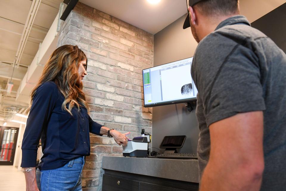 Governor Kristi Noem gets fingerprinted while purchasing a suppressor at Silencer Central ahead of an upcoming hunting trip on Tuesday, August 16, 2022, in Sioux Falls.