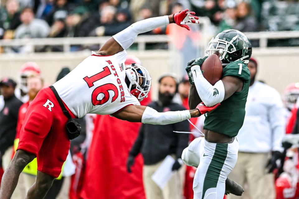 Michigan State's Jayden Reed, right, catches a pass as Rutgers' Max Melton defends during the second quarter on Saturday, Nov. 12, 2022, in East Lansing.