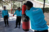 Kenyan security guards participate in physical exercise during martial arts combat training at the Chinese-run Deway Security Group compound in Kenya's capital Nairobi, March 13, 2017. REUTERS/Thomas Mukoya