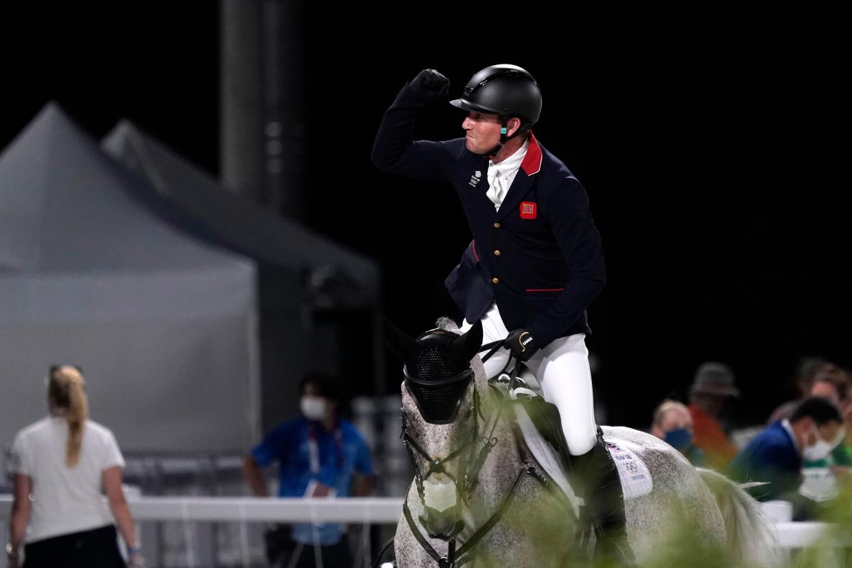 Britain's Oliver Townend, riding Ballaghmor Class, celebrates after competing during the equestrian eventing jumping at Equestrian Park in Tokyo (AP)