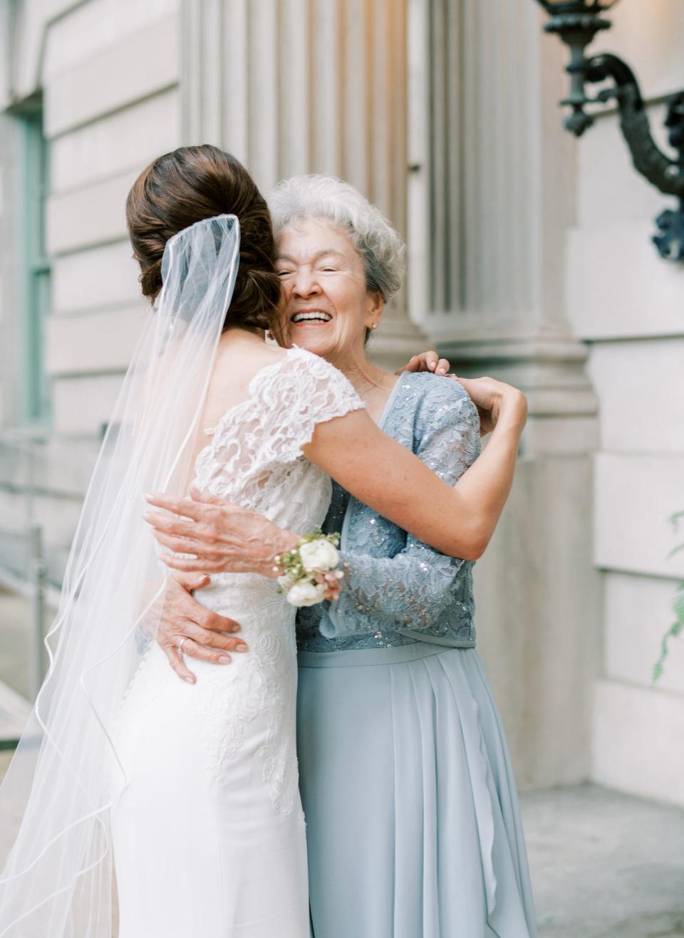 A bride hugs her grandmother.
