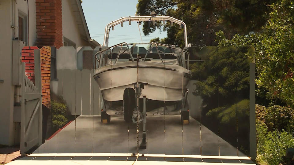 Man paints boat on fence erected to conceal boat (via KSBW)