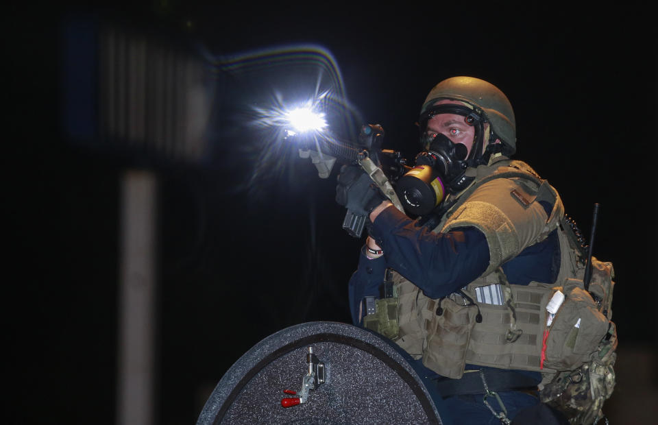 <p>Police forces fire tear gas during a protest over the killing of Michael Brown as demonstrators take streets although U.S. Missouri State Governor Jay Nixon Saturday declared a curfew and a state of emergency in Ferguson, a suburb of St. Louis, on August 17, 2014. Eighteen-year-old unarmed teen was shot dead by police in the St. Louis suburb of Ferguson, Missouri on August 09, 2014. (Bilgin Sasmaz/Anadolu Agency/Getty Images) </p>