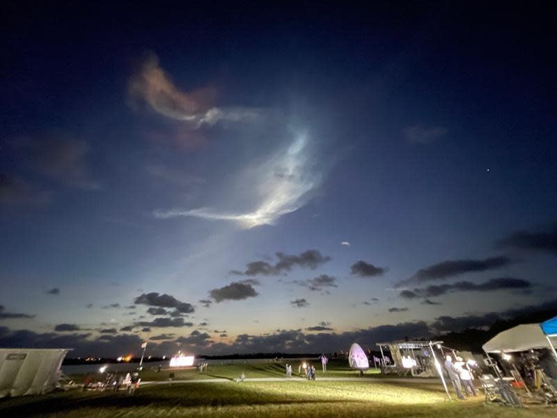 Exhaust clouds grace the dawn sky over the Kennedy Space Center press site after a SpaceX Falcon 9 rocket shot away to the northeast. / Credit: Steven Young/Spaceflight Now