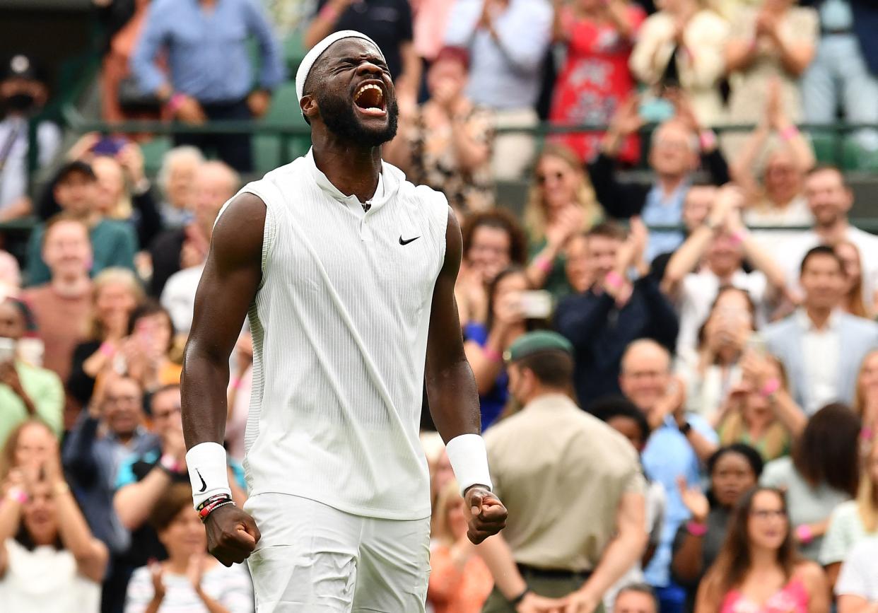 TOPSHOT - US player Frances Tiafoe celebrates his win over Greece's Stefanos Tsitsipas during their men's singles first round match on the first day of the 2021 Wimbledon Championships at The All England Tennis Club in Wimbledon, southwest London, on June 28, 2021. - - RESTRICTED TO EDITORIAL USE (Photo by Ben STANSALL / AFP) / RESTRICTED TO EDITORIAL USE (Photo by BEN STANSALL/AFP via Getty Images)