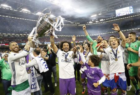 Britain Soccer Football - Juventus v Real Madrid - UEFA Champions League Final - The National Stadium of Wales, Cardiff - June 3, 2017 Real Madrid's Sergio Ramos, Marcelo and Luka Modric celebrate with the trophy after winning the UEFA Champions League Final Reuters / Carl Recine Livepic