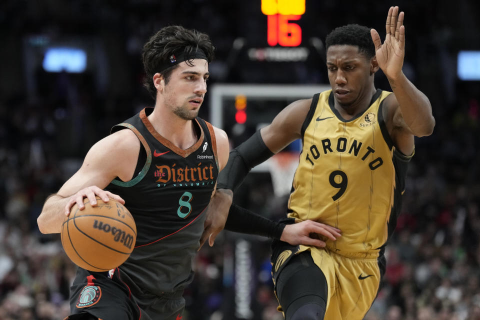 Washington Wizards forward Deni Avdija (8) moves the ball up court as Toronto Raptors guard RJ Barrett (9) defends during the second half of an NBA basketball game in Toronto on Sunday, April 7, 2024. (Frank Gunn/The Canadian Press via AP)