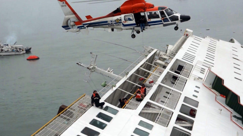 In this image taken from video released by News Y via Yonhap, passengers from a ferry sinking off South Korea's southern coast, are rescued by a South Korean Coast Guard helicopter in the water off the southern coast near Jindo, south of Seoul, Wednesday, April 16, 2014. Nearly 300 people were still missing Wednesday several hours after the ferry carrying 477, most of them high school students, sank in cold waters off South Korea's southern coast. (AP Photo/Yonhap) KOREA OUT