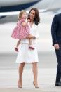 <p>In an all white Alexander McQueen coat dress with nude heels while arriving at the Warsaw airport. </p>