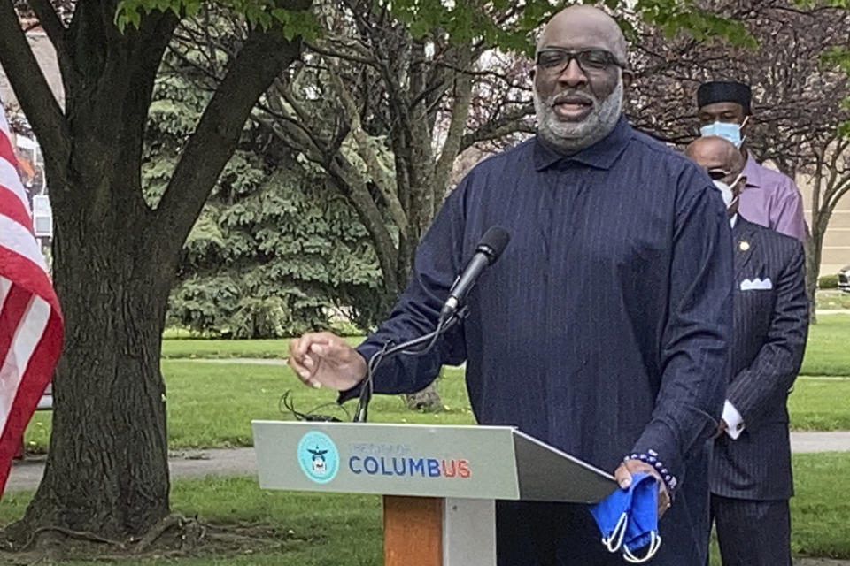 FILE - Bishop Timothy Clarke of First Church of God in Columbus, right, calls for peaceful protests during the trial for the officer charged in killing George Floyd, at a news conference Monday, April 19, 2021, in Columbus, Ohio. Clarke describes himself as “biblically pro-life,” yet he criticizes the stringent abortion bans being enacted in numerous Republican-led states as “excessive and extreme.” Referring to laws that would criminalize abortion-providing doctors and deny abortion to victims of rape, he said many people in his church “are saying this is going too far. It’s beyond the pale.” (AP Photo/Andrew Welsh-Huggins, File)