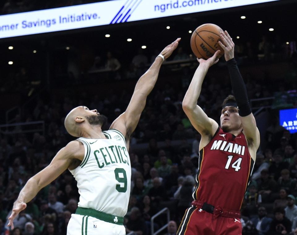 Apr 21, 2024; Boston, Massachusetts, USA; Miami Heat guard Tyler Herro (14) shoots the ball over Boston Celtics guard Derrick White (9) during the first half in game one of the first round for the 2024 NBA playoffs at TD Garden. Mandatory Credit: Bob DeChiara-USA TODAY Sports