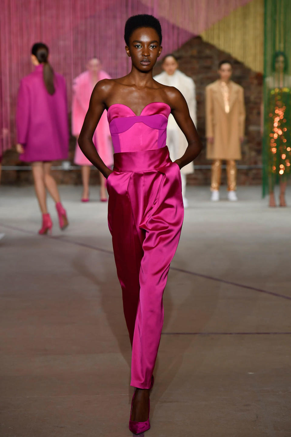 <p>Model wears a fuchsia evening jumpsuit at the Milly Fall/Winter 2018 show. (Photo: Courtesy of Greg Kessler) </p>