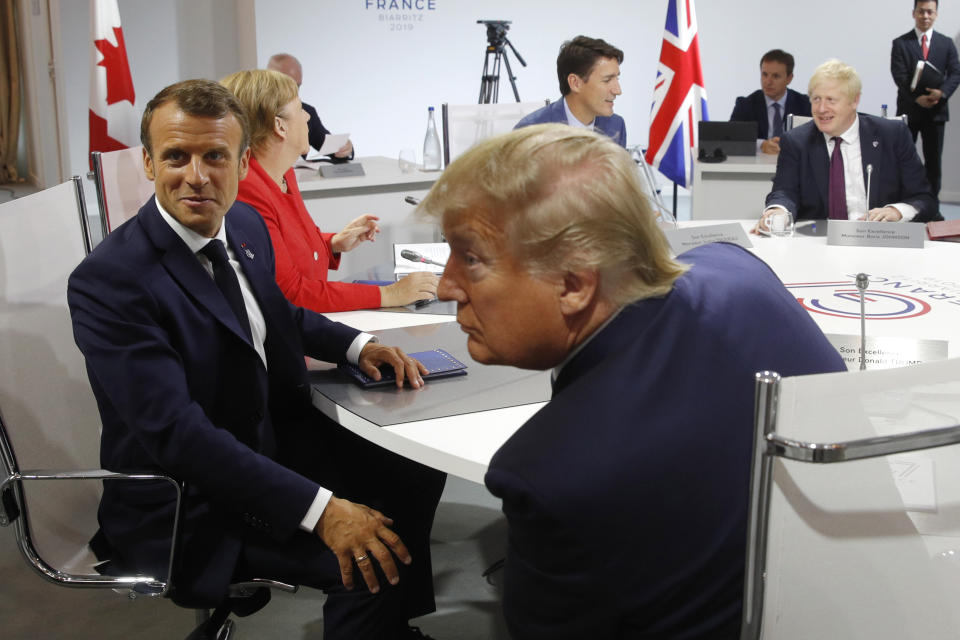 French President Emmanuel Macron, left, U.S. President Donald Trump with Britain's Prime Minister Boris Johnson, right, and Canadian Prime Minister Justin Trudeau attend a G7 working session on "International Economy and Trade, and International Security Agenda" during the G7 summit in Biarritz, southwestern France, Saturday Aug. 25, 2019. Leaders of major world economies are meeting to discuss the shaky world economy amid trade disputes and uncertainty over U.S. President Donald Trump's policies. (Philippe Wojazer/Pool via AP)