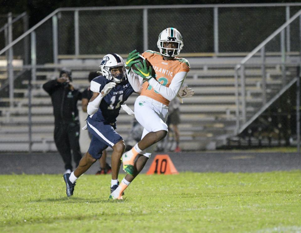 Atlantic's Kamare Williams catches a pass from Lincoln Graf and turns up-field for a big gain during the first half of Friday's 32-14 victory over Dwyer on Oct. 21, 2022.