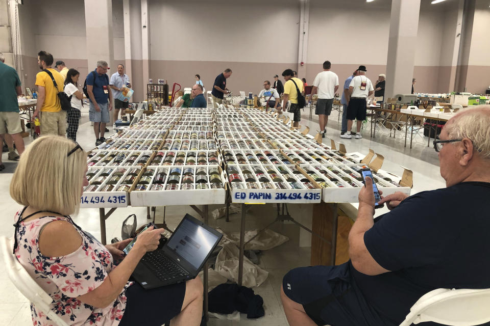 Collectors of vintage beer cans sit at their table on Thursday, Aug. 29, 2019, in Albuquerque, N.M., at the 49th annual gathering of members of the Brewery Collectibles Club of America. Collectors from around the world began Thursday buying, trading and selling containers of brews at the annual four-day event billed the "CANvention." (AP Photo/Russell Contreras)