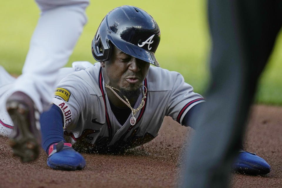 Atlanta Braves' Ozzie Albies slides into third base against the Cleveland Guardians, advancing from first on a hit by Austin Riley during the third inning of a baseball game Wednesday, July 5, 2023, in Cleveland. (AP Photo/Sue Ogrocki)