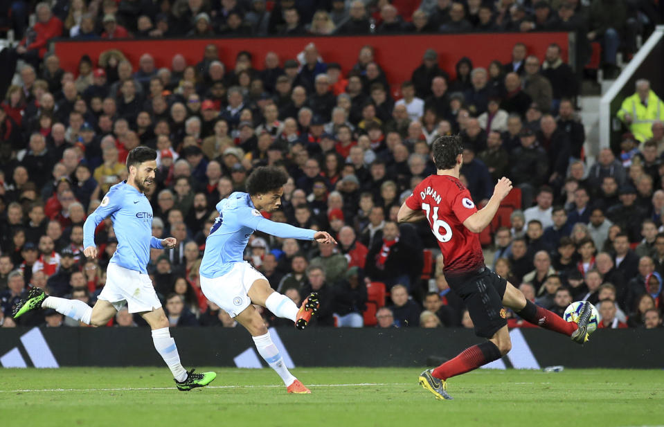 Manchester City's Leroy Sane, center, scores his side's second goal during the English Premier League soccer match between Manchester United and Manchester City at Old Trafford Stadium in Manchester, England, Wednesday April 24, 2019. (AP Photo/Jon Super)