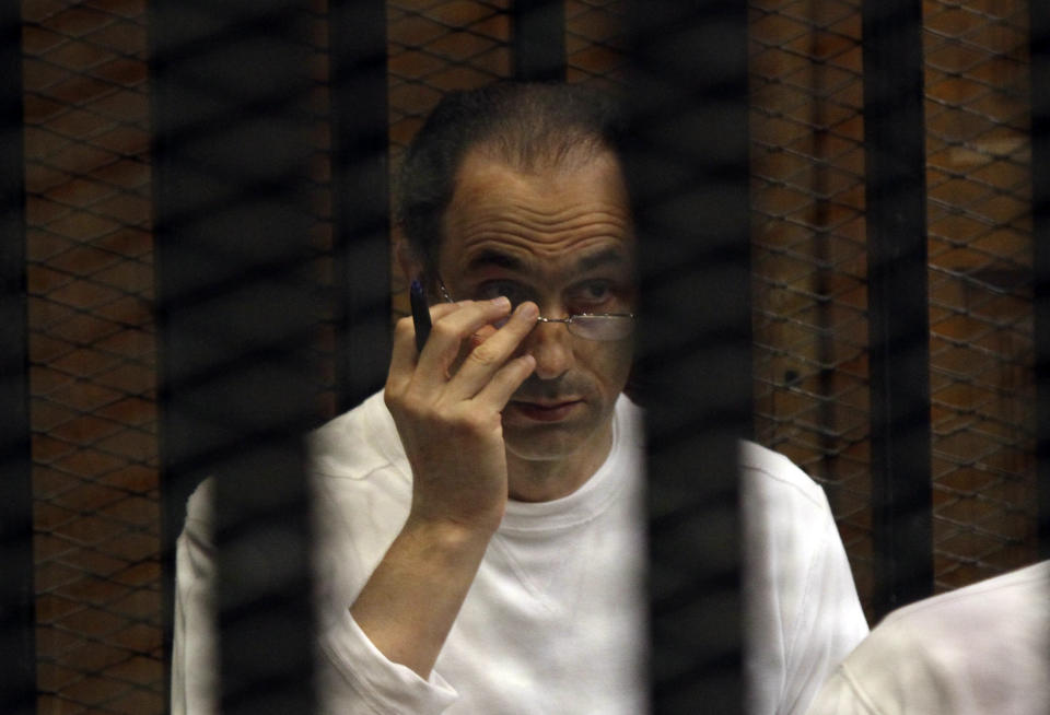 Gamal Mubarak sits behind bars at the second session of his trial on charges of insider trading in Cairo Criminal Court in Cairo, Egypt, Saturday Sept. 8, 2012. Gamal Mubarak, a onetime heir apparent to the Egyptian Presidency, was acquitted on June 2, 2012 of separate corruption charges. He has been in detention since April 2011. Gamal's father, Hosni Mubarak, was ousted last year in a popular uprising and is serving a life sentence. (AP Photo/Ahmed Gomaa) -