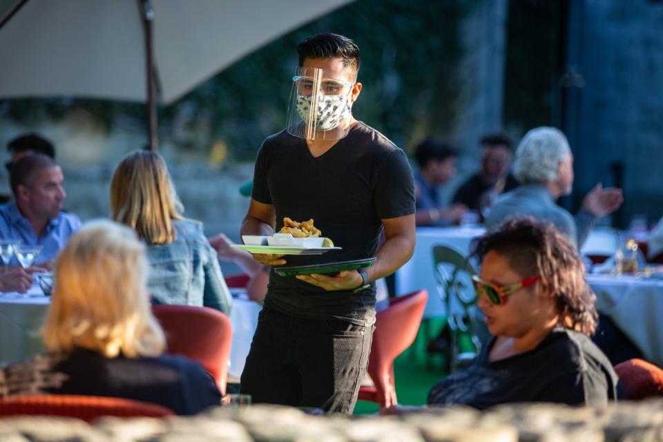 Customers dine on the outdoor patio at La Boheme in West Hollywood in July, 2020.