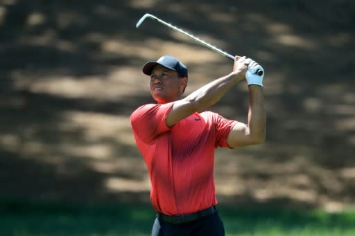 Tiger Woods plays his second shot from the second fairway