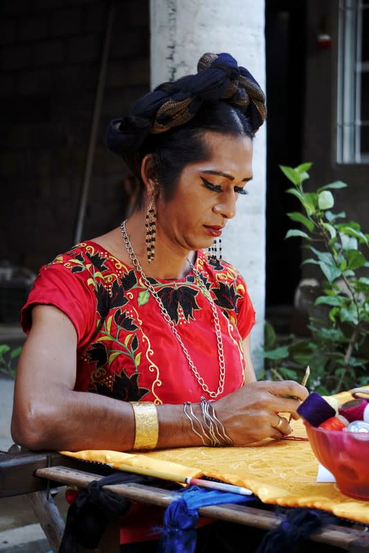 Estrella Vasquez, a muxe woman who features on the cover of Vogue magazine, paints a Huipil at her house in Juchitan