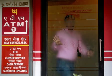 FILE PHOTO: A man leaves an automated teller machine (ATM) facility of Punjab National Bank (PNB) in New Delhi, India, February 27, 2018. REUTERS/Saumya Khandelwal/File Photo