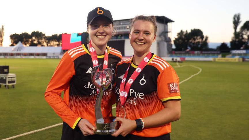 Sarah (l) and Kathryn Bryce with the Charlotte Edwards Cup