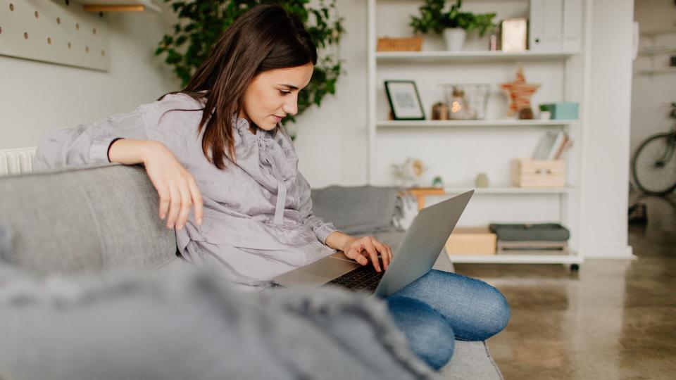 Young woman using computer at home.