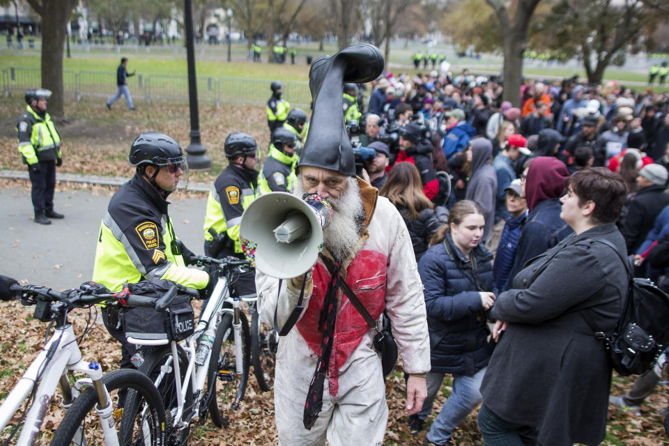 <p>Vermin Supreme speaks to police through his megaphone next to counterprotesters of an Alt-Right organized free speech event on the Boston Common on Nov. 18, 2017, in Boston, Mass. (Photo: Scott Eisen/Getty Images) </p>