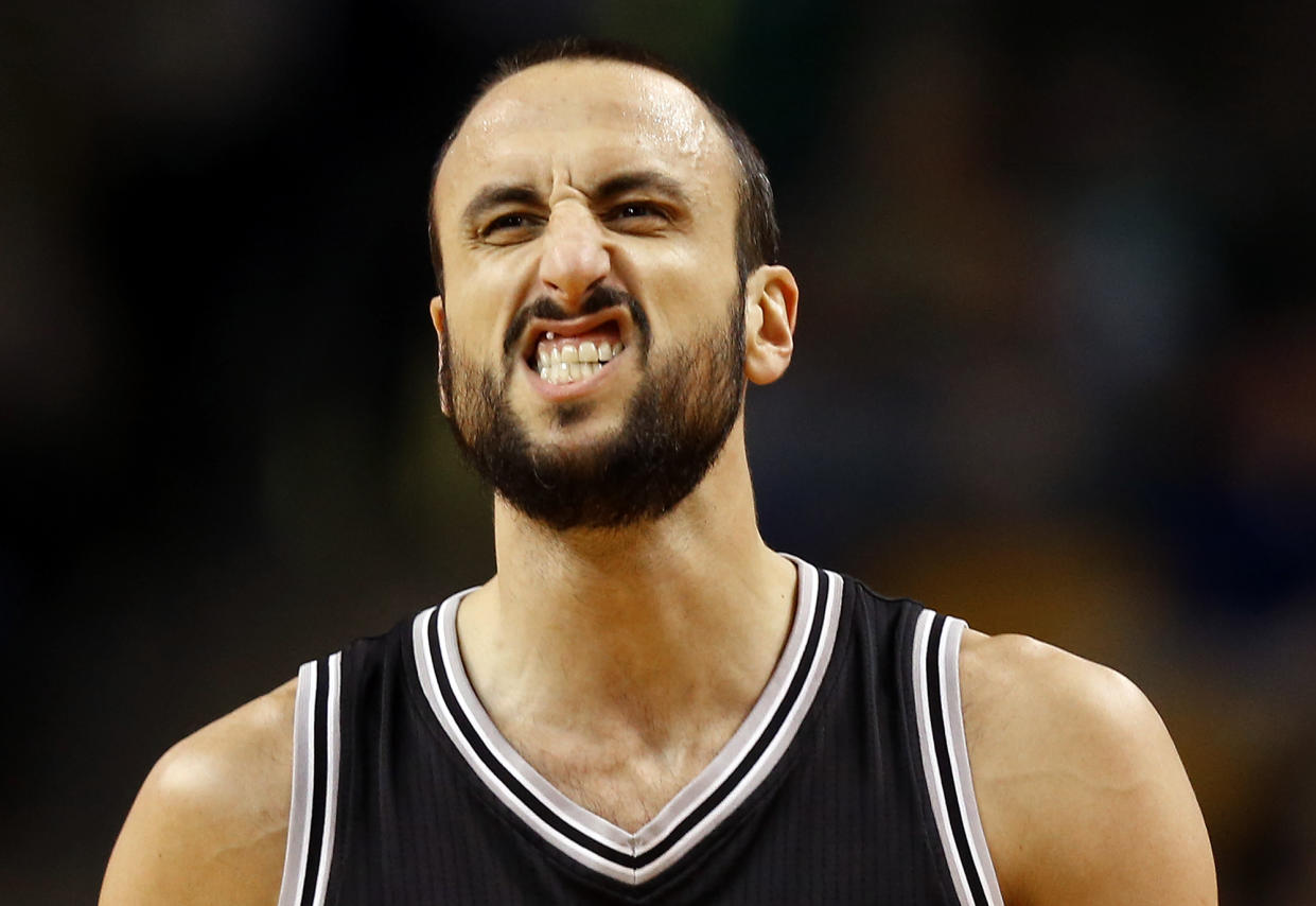 Manu Ginobili grits his teeth and powers through it. (AP)