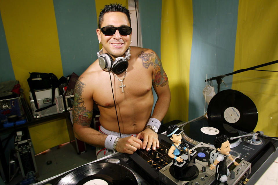 DJ Skribble stands over his turntable during a taping for MTV Spring Break 2003 at the Surfcomber Hotel March 12, 2003 in Miami Beach, Florida.&nbsp;