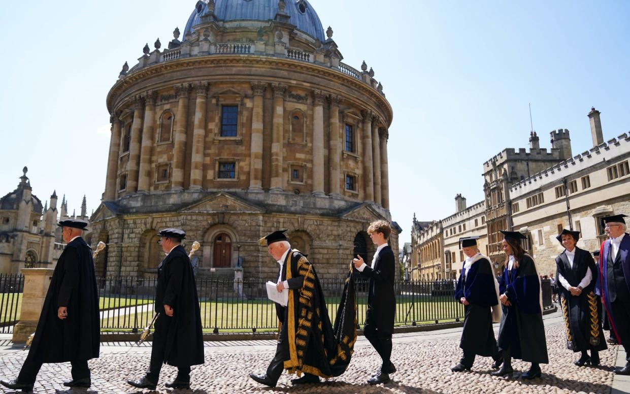 A procession makes its way past Radcliffe Camera, Oxford, as part of an Oxford University degree ceremony - PA