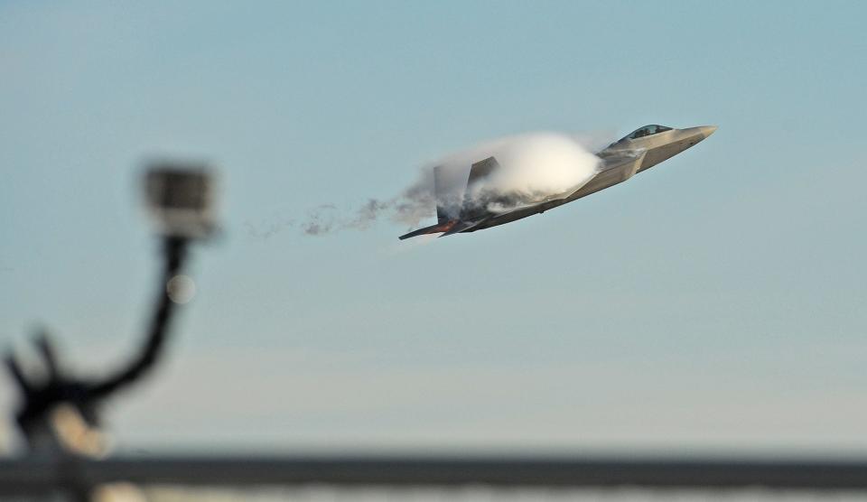 A small fence-mounted films an F-22 Raptor taking off over the Savannah Combat Readiness Training Center Thursday morning. The plane from the Hawaii Air National Guard was on its way to participate in a training dogfight over the Atlantic Ocean as part of the month-long Sentry Savannah 2014 operation being run the Georgia Air National Guard training center.