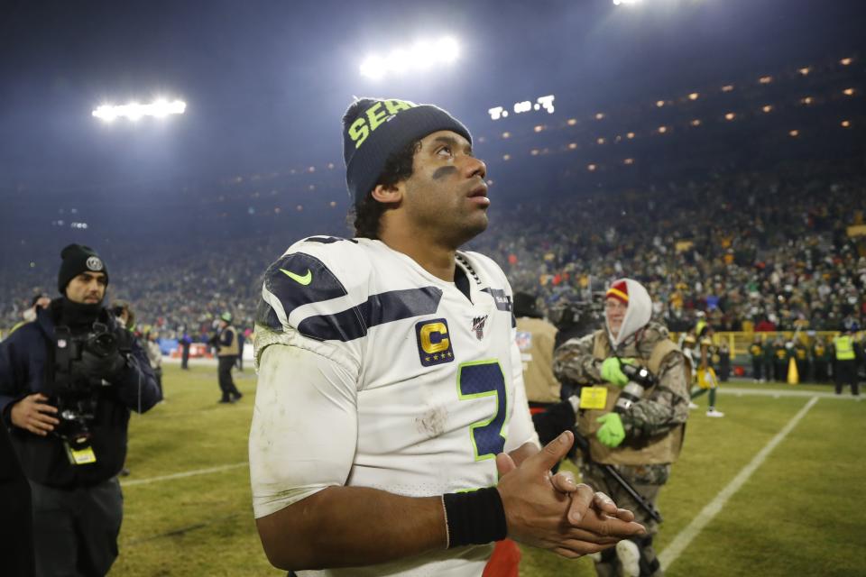 Seattle Seahawks' Russell Wilson walks off the field after an NFL divisional playoff football game against the Green Bay Packers Sunday, Jan. 12, 2020, in Green Bay, Wis. The Packers won 28-23 to advance to the NFC Championship. (AP Photo/Matt Ludtke)