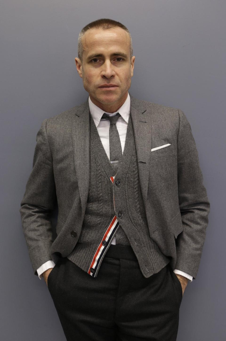 Fashion designer Thom Browne poses for a photograph at his Hudson Street store in New York, Wednesday, Feb. 20, 2013. Browne is building a business _ and what he hopes is a smart, long-lasting business at that. He's just not the overzealous, mercurial artiste. (AP Photo/Kathy Willens)