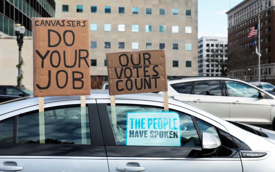 Demonstrators in a car caravan demand the Board of State Canvassers to certify the results of the election in Lansing, Michigan, U.S - Reuters