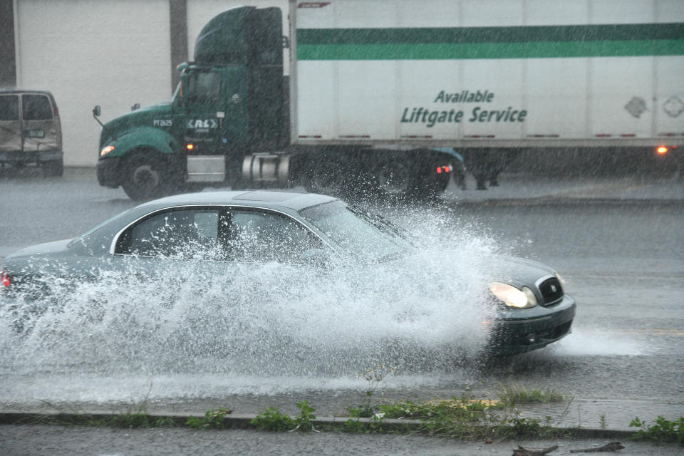 A car appears covered in water as it drives down a flooded Hollywood Boulevard Thursday afternoon.