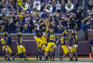 Michigan linebacker Junior Colson (25) celebrates his recovery of a Rutgers fumble with teammates in the fourth quarter of an NCAA college football game in Ann Arbor, Mich., Saturday, Sept. 25, 2021. (AP Photo/Tony Ding)