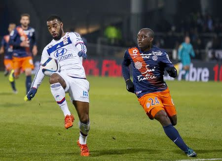 Football Soccer - Olympique Lyon v Montpellier - French Ligue 1 - Gerland stadium, Lyon, France - 27/11/2015 Olympique Lyon's Alexandre Lacazette (C) in action against Montpellier's Jerome Roussillon (R)REUTERS/Robert Pratta