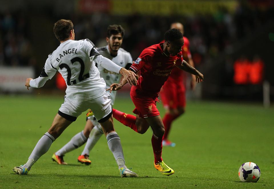 Swansea City's Angel Rangel (left) and Liverpool's Raheem Sterling battle for the ball