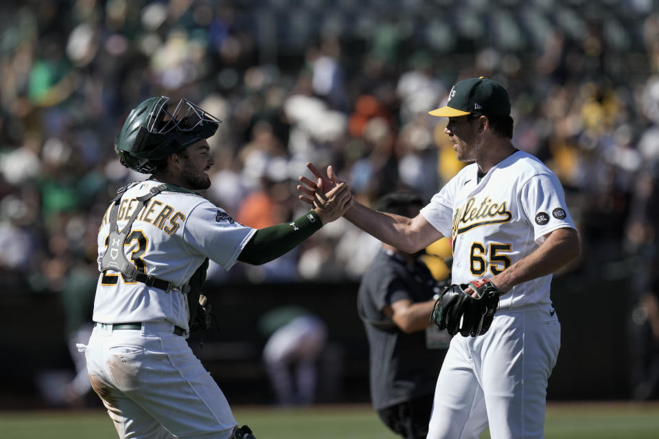 Oakland Athletics catcher Shea Langeliers, left, and pitcher Trevor May celebrate after their victory over the San Francisco Giants in a baseball game Sunday, Aug. 6, 2023, in Oakland, Calif. (AP Photo/Godofredo A. Vásquez)