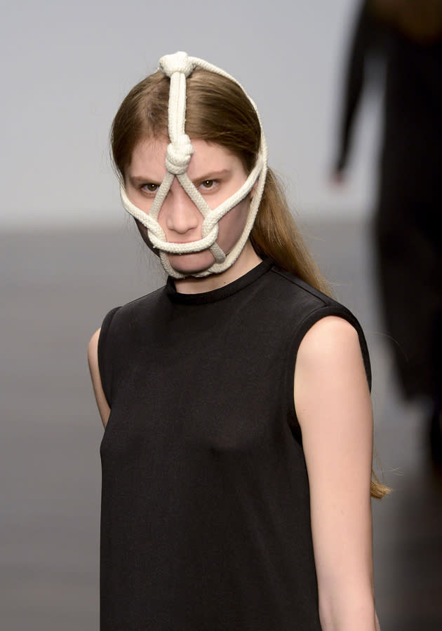 <b>London Fashion Week AW13: Central St Martins MA</b><br><br>This model was denied the right to speak thanks to her weird rope face mask.<br><br>© Getty