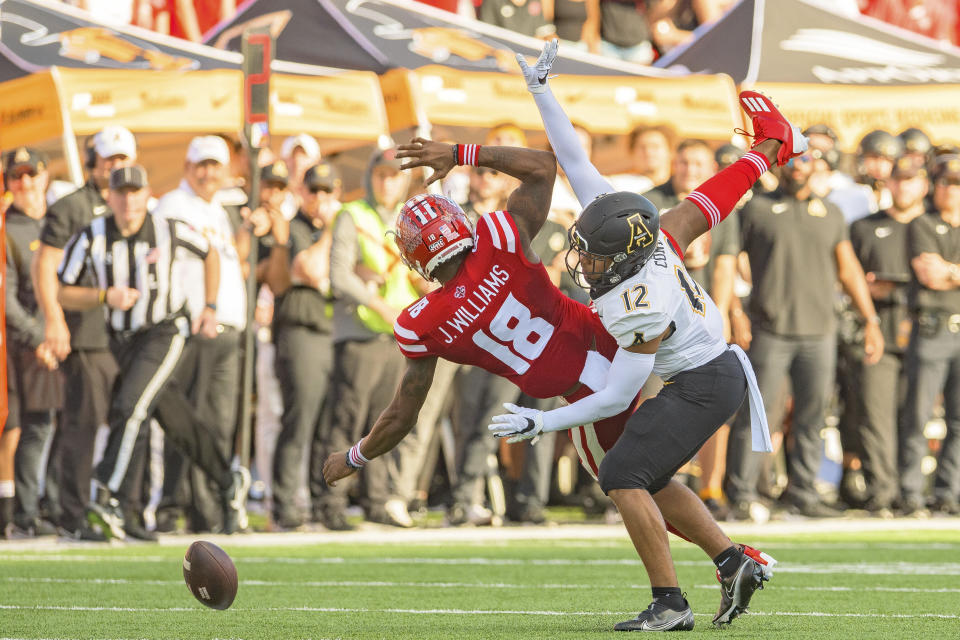 Louisiana-Lafayette wide receiver Michael Jefferson (8) drops a pass against Appalachian State defensive back Madison Cone (12) during the first half of the Sun Belt Conference championship NCAA college football game in Lafayette, La., Saturday, Dec. 4, 2021. (AP Photo/Matthew Hinton)