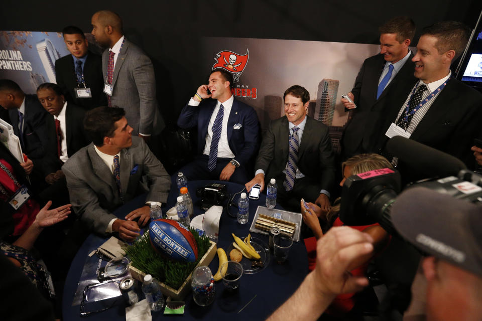 Blake Bortles, center, from Central Florida, takes a call before being selected third overall by the Jacksonville Jaguars in the first round of the NFL football draft, Thursday, May 8, 2014, at Radio City Music Hall in New York. (AP Photo/Jason DeCrow)